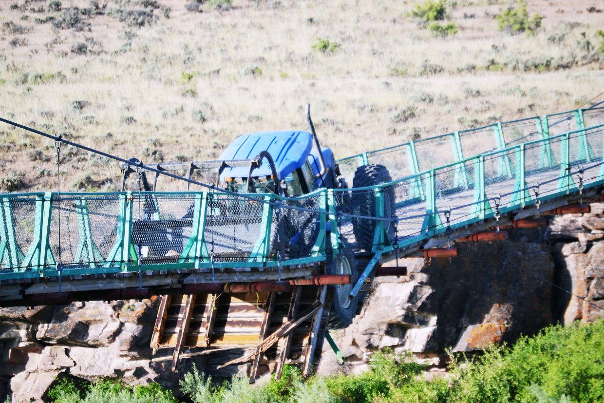 Tractor removed from Swinging Bridge in Browns Park | CraigDailyPress.com