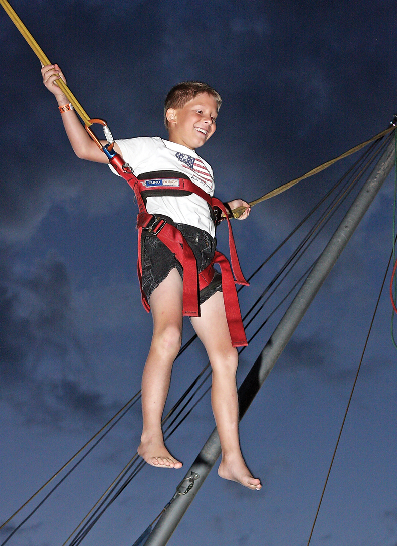 Wesley Owens, 10, smiles while jumping in the bungee trampoline during the Fun Zone Amusements Carnival on Thursday at the Moffat County Fairgrounds.