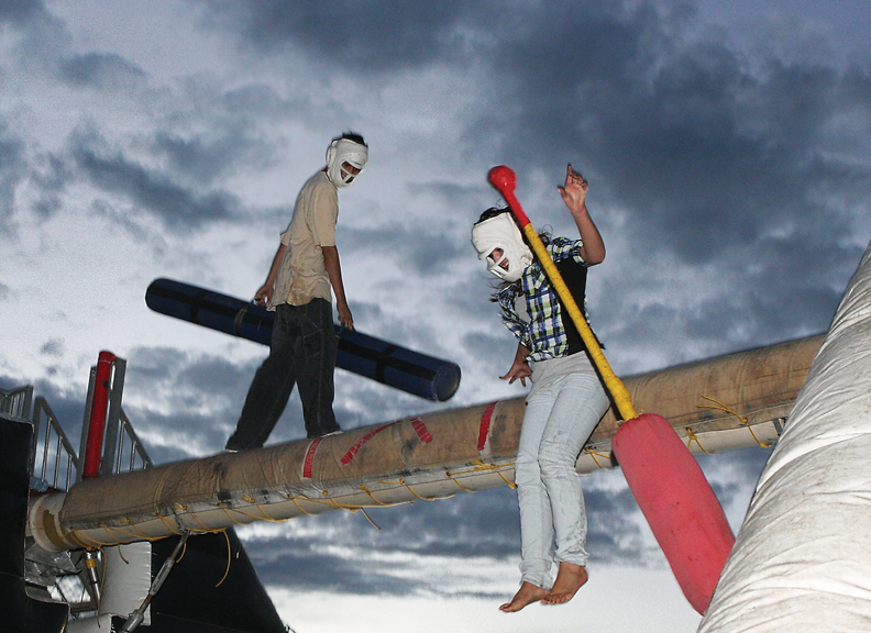 Miguel Cruz, 14, knocks Daniela Martinez, 16, off the padded log at a jousting attraction during the Fun Zone Amusements Carnival on Thursday at the Moffat County Fairgrounds.