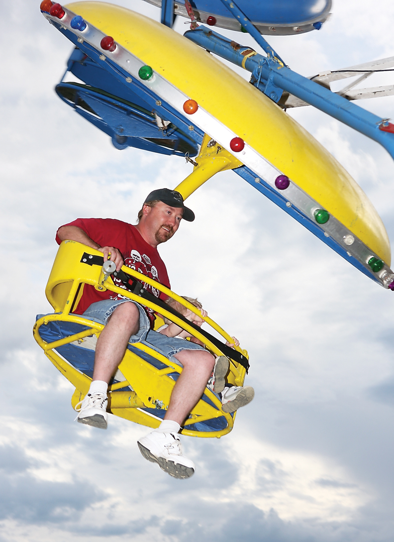 Dan Smith and his son, Justin, 3, ride the Trooper during the carnival Saturday at the Moffat County Fairgrounds.