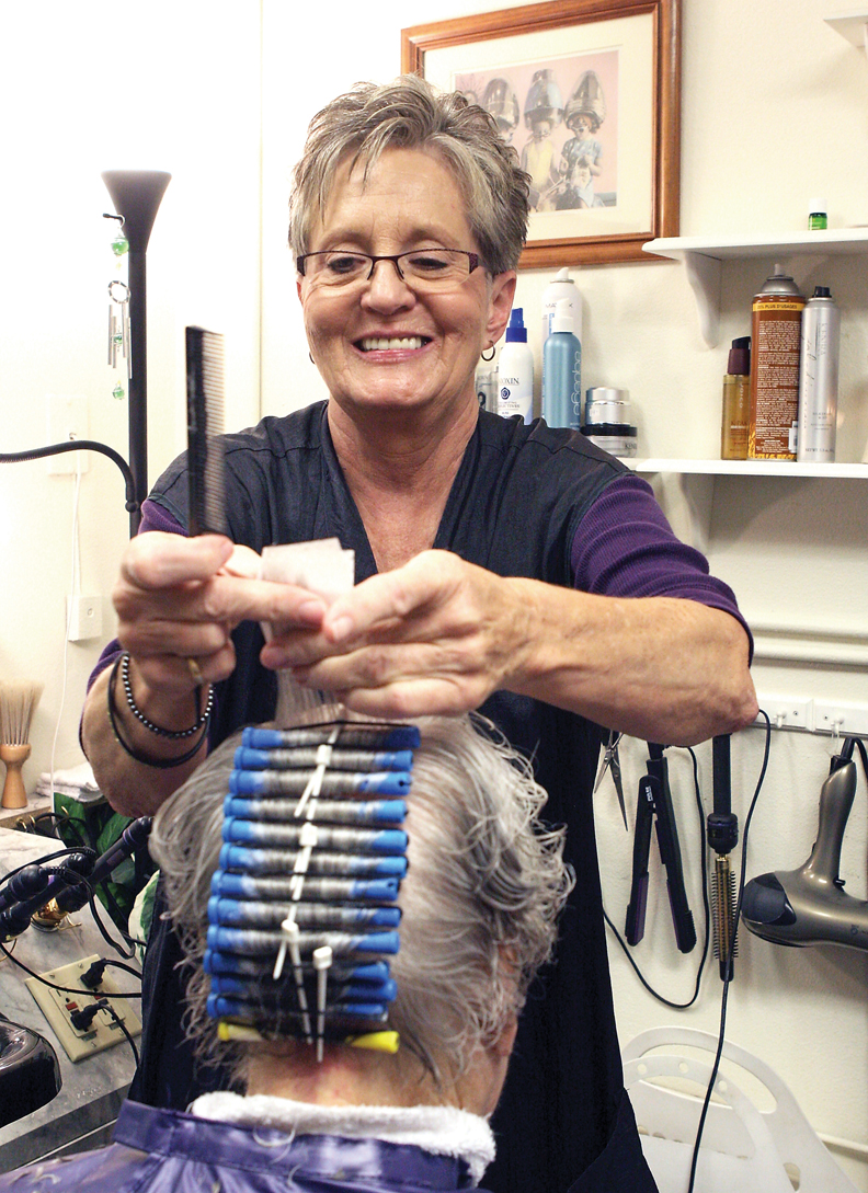 LaDawn Sexton rolls a lock of Anne Visintainer’s hair Wednesday at Accent on Beauty at Sunset Meadows I. Visintainer, 80, gets her hair fixed once every week and a perm once every three months.