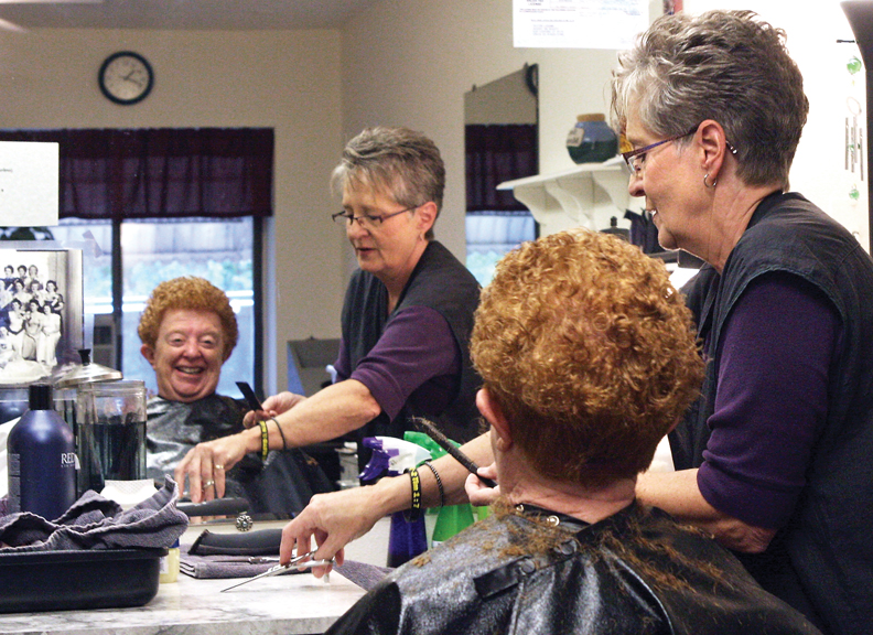 LaDawn Sexton reaches for her scissors while cutting the hair of Esther Self, 63, Wednesday at Accent on Beauty in Sunset Meadows. Self and Sexton graduated from Moffat County High School together in the class of 1965.