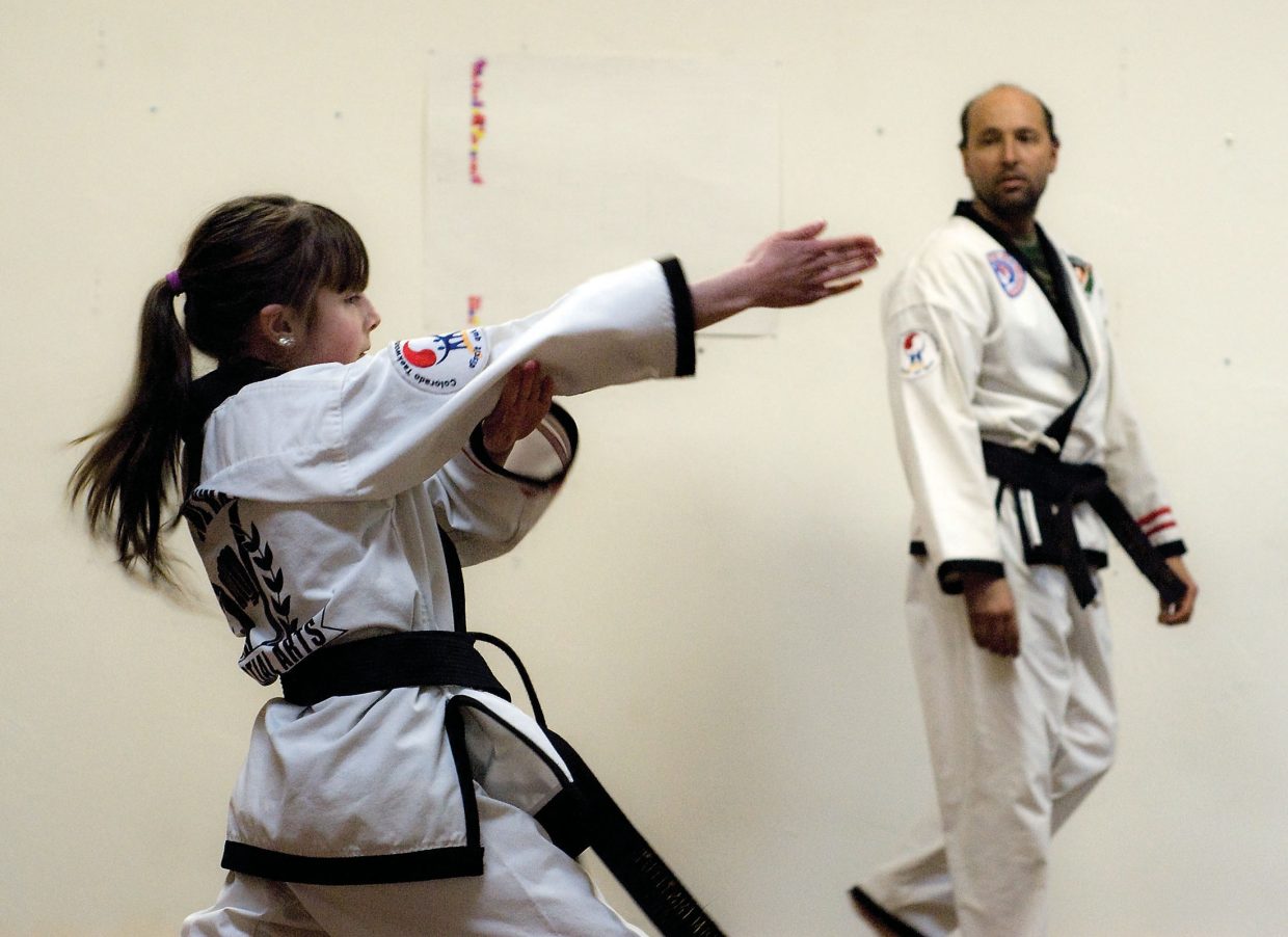 Hannah Walker, 10, practices a Poomse, which is a type of choreographed fight sequence, Wednesday during class. Hannah, instructor Jason Walker's daughter, began learning Taekwondo eight years ago.

