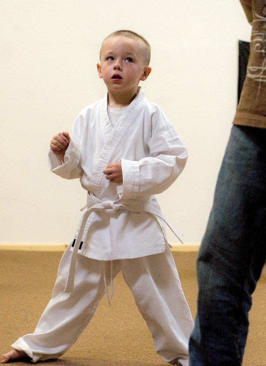 Hunter Snow, 4, looks for his next move during class Wednesday. Snow, new to Taekwondo, is among Walker's youngest students.
