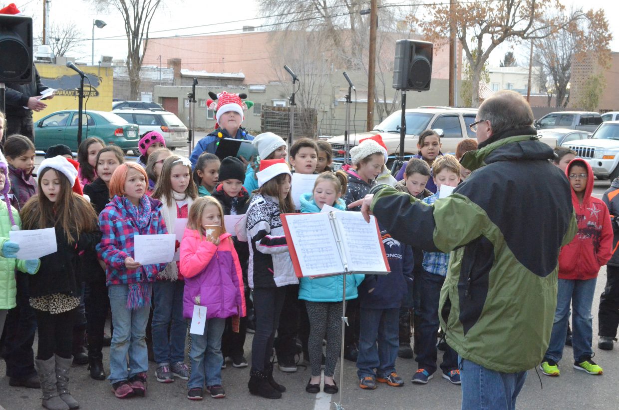 Members of the combined elementary school choirs perform during Down Home Christmas Celebration Saturday at Alice Pleasant Park.