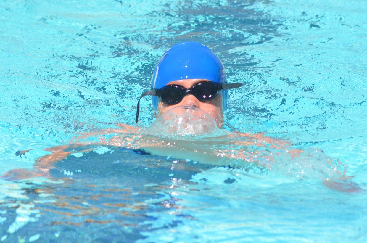 Travis LeFevre spits out a mouthful of water as he races during the Craig Sea Sharks' ABC Meet Saturday morning at the Craig City Pool Complex.