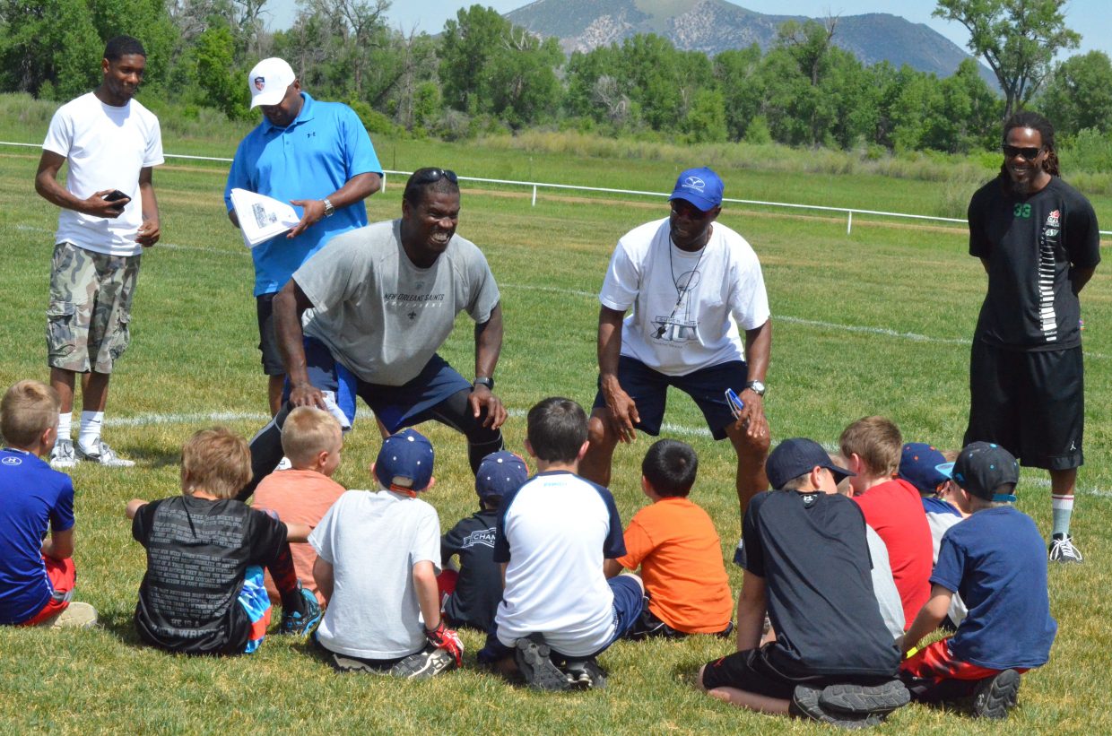 Former NFL stars Anthony Hargrove and Rick Upchurch show young athletes how to put on their game face during the NFL Play 60 Challenge Saturday at Loudy-Simpson Park as part of the Victory Motors Cancer Drive.