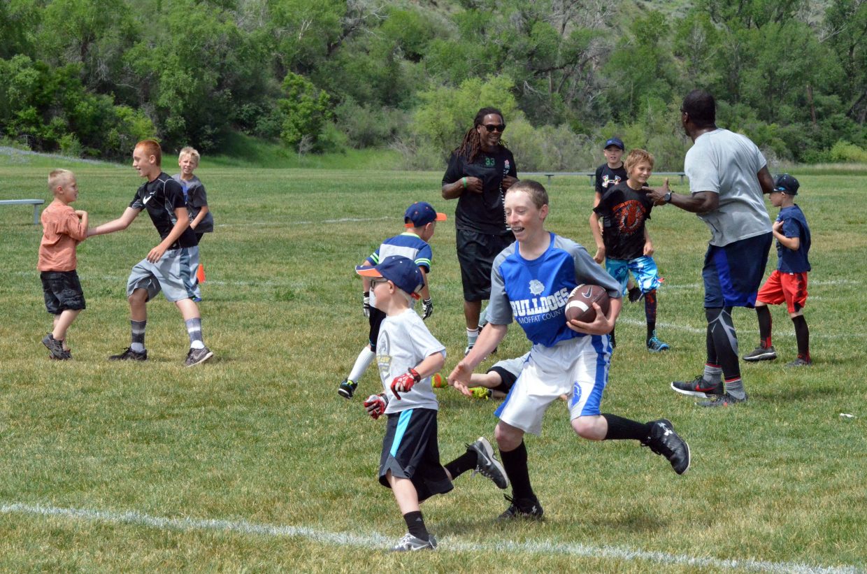 Participants in the NFL Play 60 Challenge stay on their feet for a game of tag Saturday at Loudy-Simpson Park as part of the Victory Motors Cancer Drive.