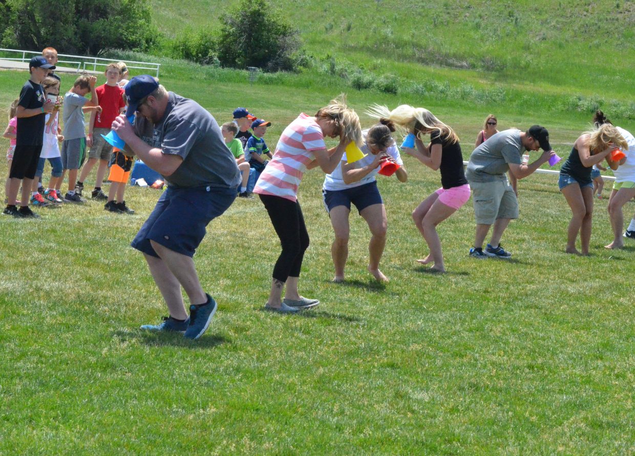 Adults get themselves good and dizzy and ready to run the field as part of the NFL Play 60 Challenge Saturday at Loudy-Simpson Park. Play 60 emphasizes physical activity for kids as well as parental involvement in their activities.