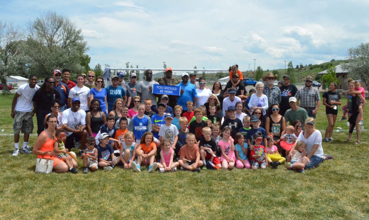 Community members gather on the fields of Loudy-Simpson Park following the NFL Play 60 Challenge, which featured instruction from numerous professional football players as part of the Victory Motors Cancer Drive. The Saturday event was a fundraiser full of family activities, including a 5K Color Run and appearances by Denver Broncos cheerleaders, to raise money for Moffat County Cancer Society.