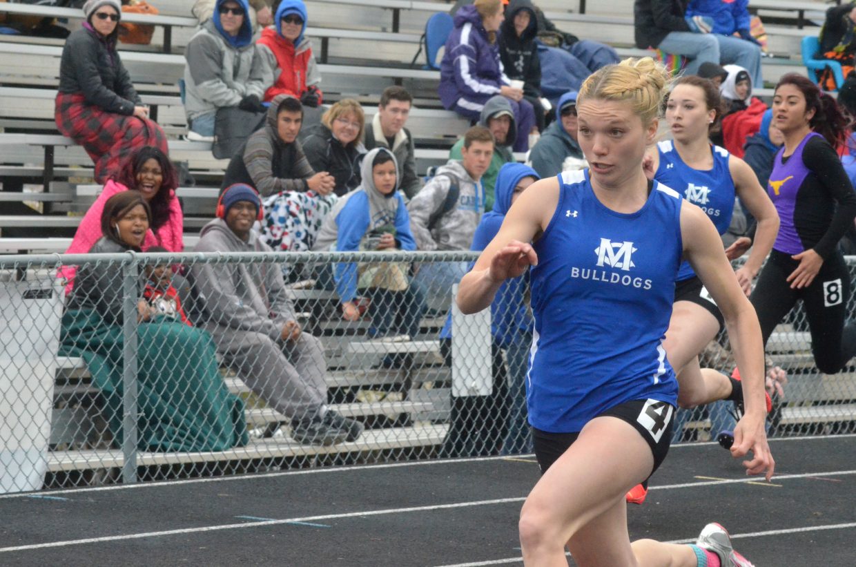 Moffat County High School's Kayla Pinnt, foreground, speeds ahead of the competition with younger sister Quinn close behind in the 100-meter dash. Kayla won both the 100 and 200 races during Friday's Clint Wells Invitational at MCHS.