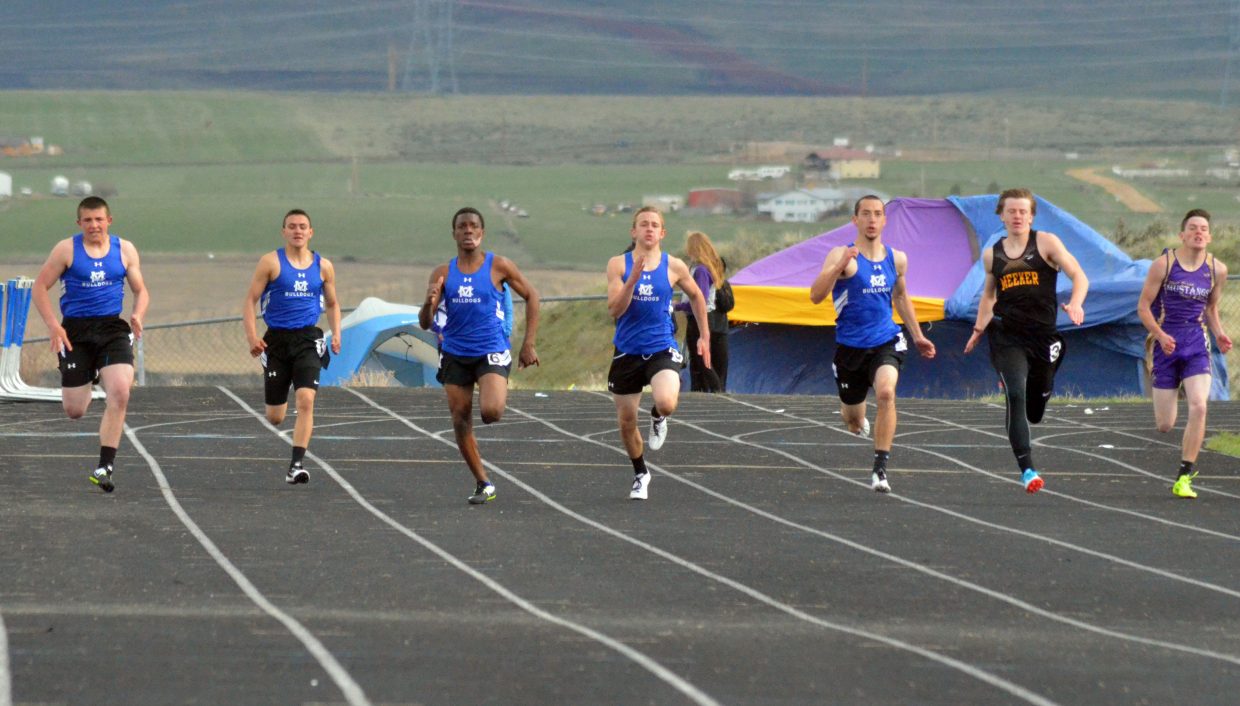 From left, Moffat County High School sprinters Elias Peroulis, Victor Silva, Gary Warrior, Kaden Hafey and Shandon Hadley tear down the track during the boys 200-meter dash Friday at the Clint Wells Invitational. Hadley won the race, one of 16 individual events in which MCHS took first place, the Bulldogs boys and girls teams also winning the overall meet.