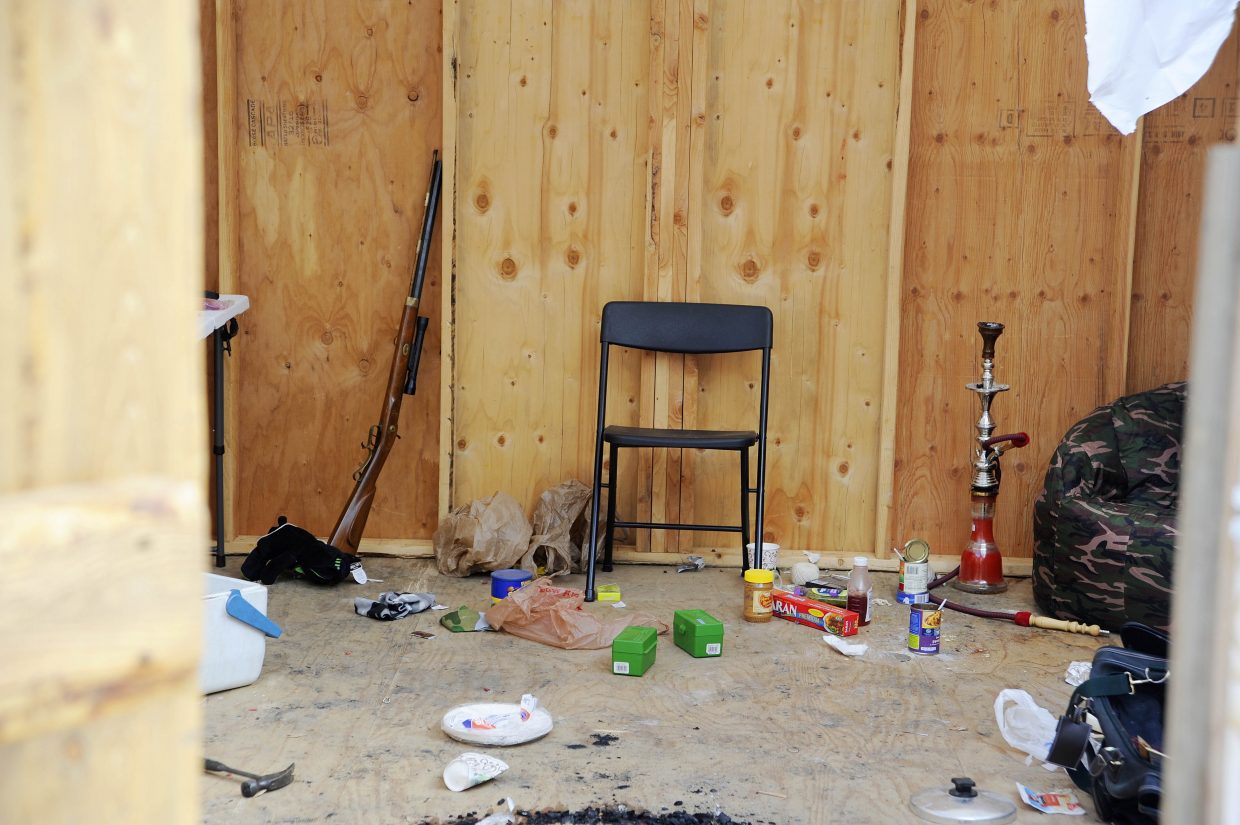 Deputies collected evidence, including a rifle, from inside the shack.