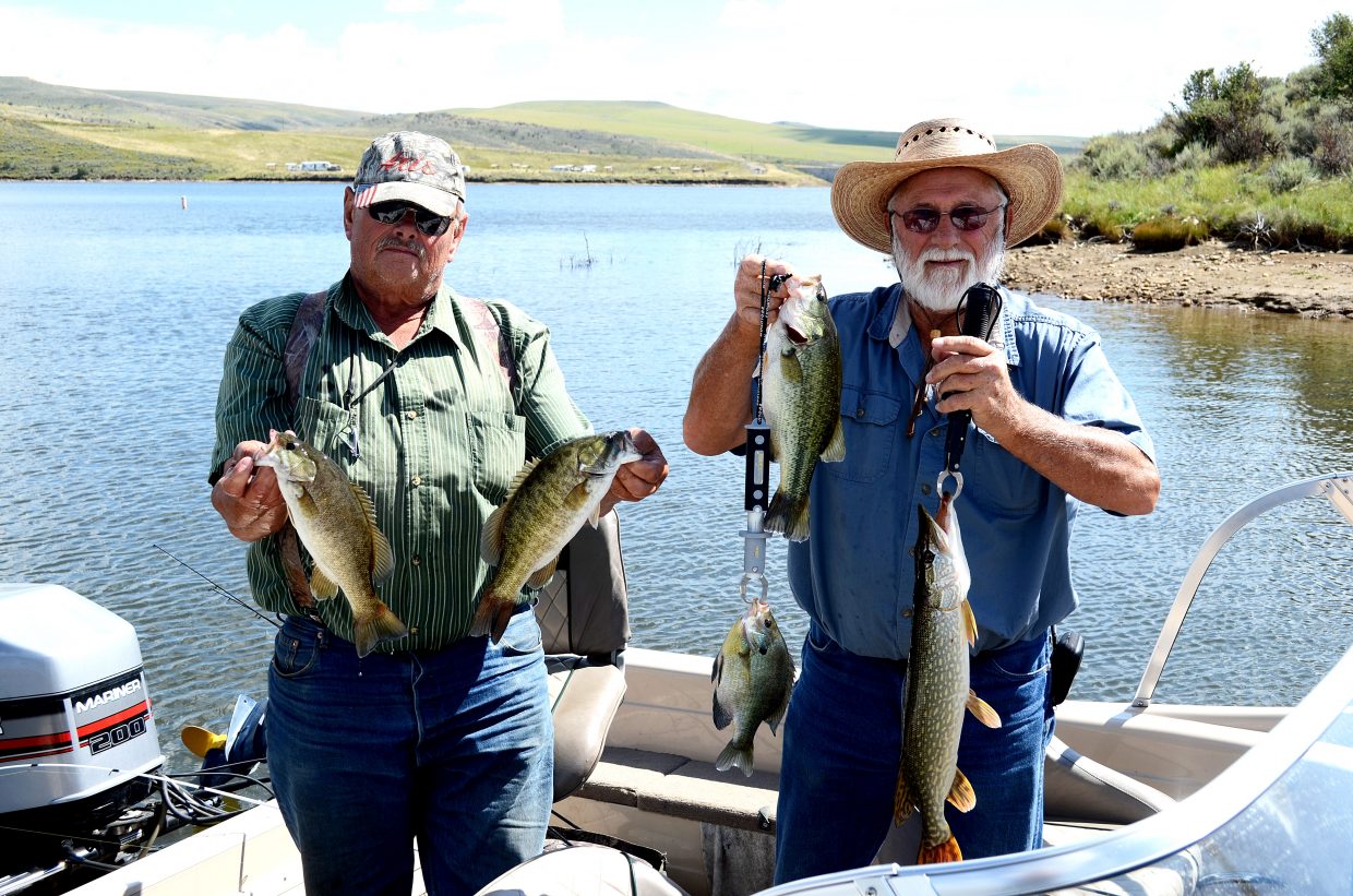 Norm Fedde, left, and Burt Clements show off the fish they caught Thursday at Elkhead Reservoir. Fedde holds  a small-mouth bass, and Clements holds a blue gill, a large-mouth bass and a northern pike. The small-mouth bass and northern pike pose a threat to four endangered fish along the Yampa River.