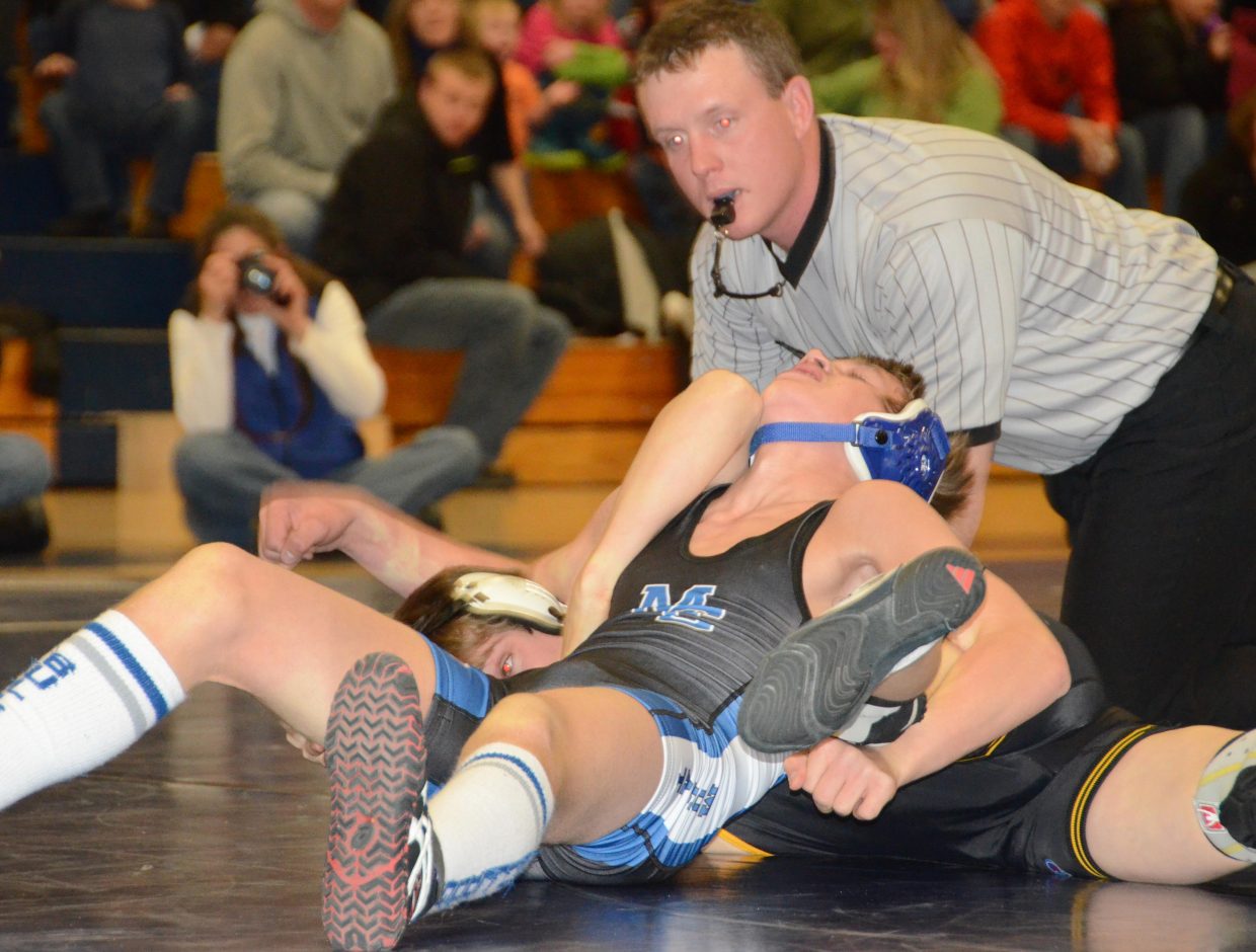 Devlyn Mosman picks up a reversal on Sheridan Harvey, of Meeker, on Tuesday at Moffat County High School. Mosman went on to lose the match by retiring with injury later on.