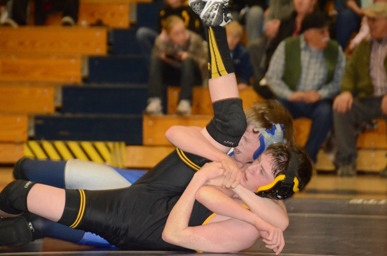 Garrett Uptain flips Meeker's Nick Burri over for a pin Tuesday in Craig. Uptain, wrestling at 120 pounds for Moffat County's JV team, picked up a win, but Meeker won the varsity dual, 54-30.