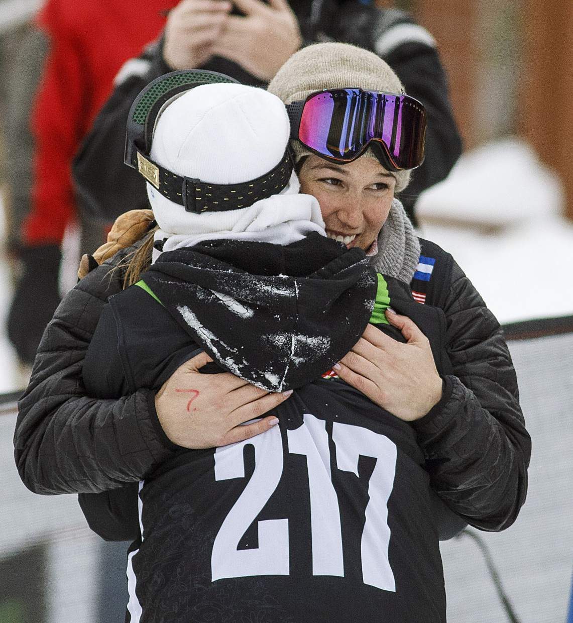 Spencer O'Brien of Canada, with purple googles, hugs Enni Rukajarvi of Finland following their last run in the slopestyle finals during the Dew Tour event Saturday, Dec. 16, at Breckenridge Ski Resort.