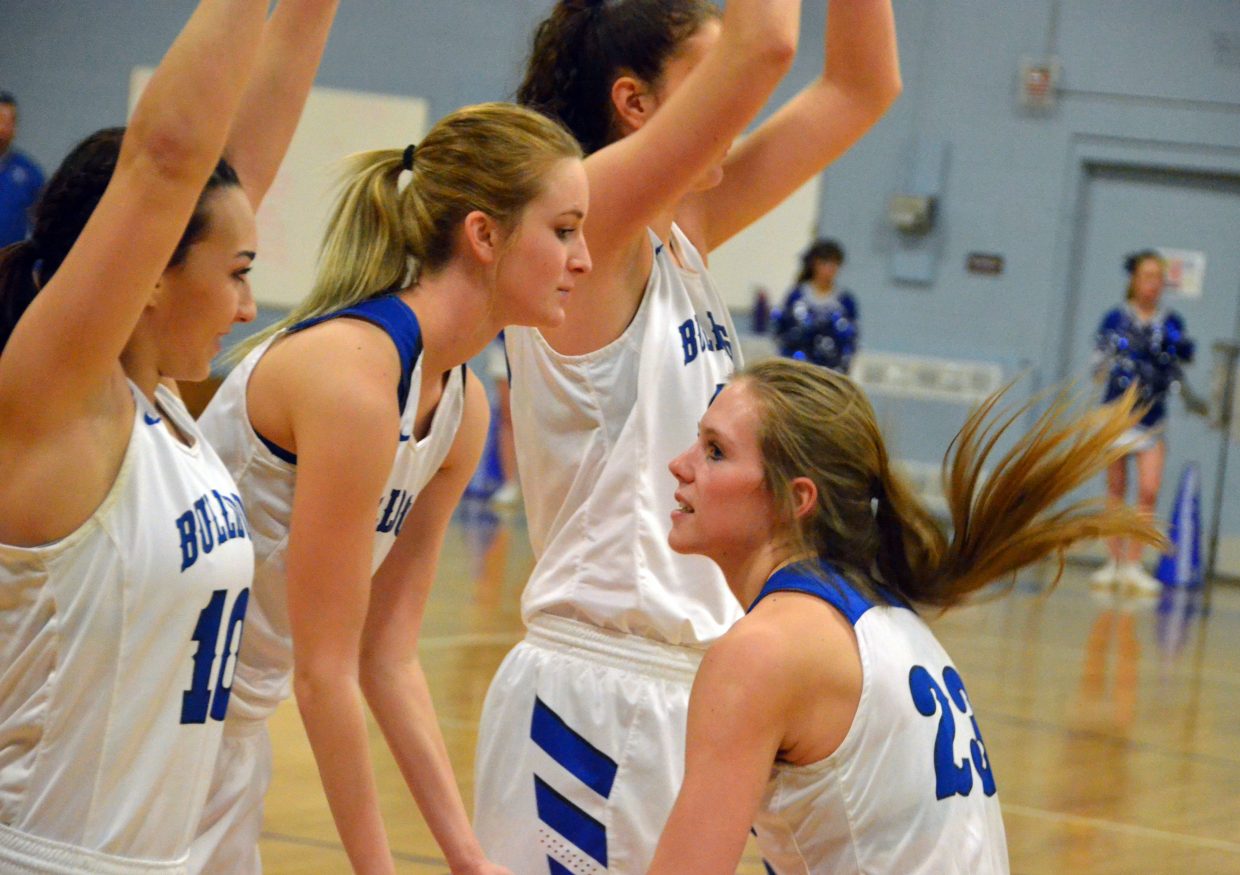 Moffat County High School's Jaci McDiffett exchanges high fives with teammates Quinn Pinnt, left, Kinlie Brennise and Brooke Gumber during pre-game warmups.
