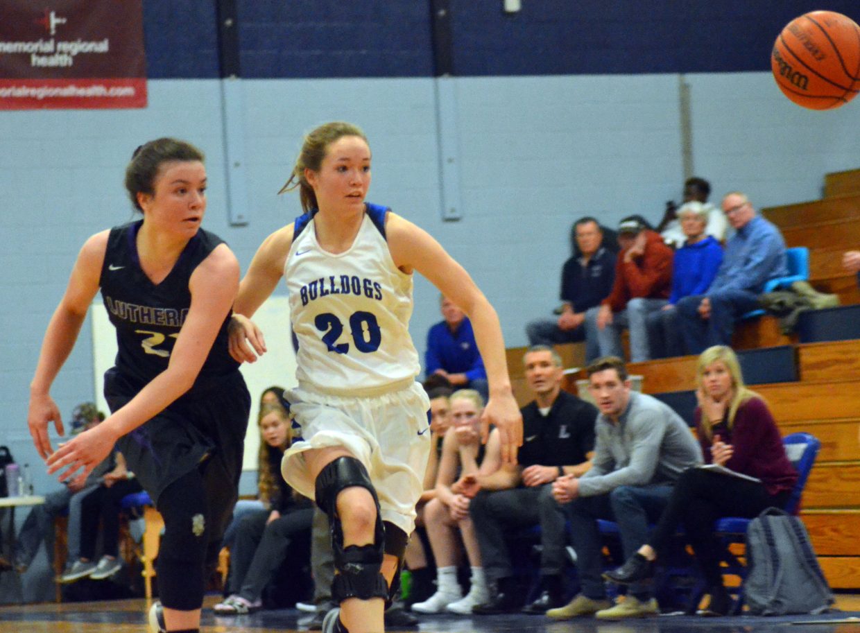 Moffat County High School's Madie Weber and Lutheran's Lexi Wilmoth pursue a loose ball.