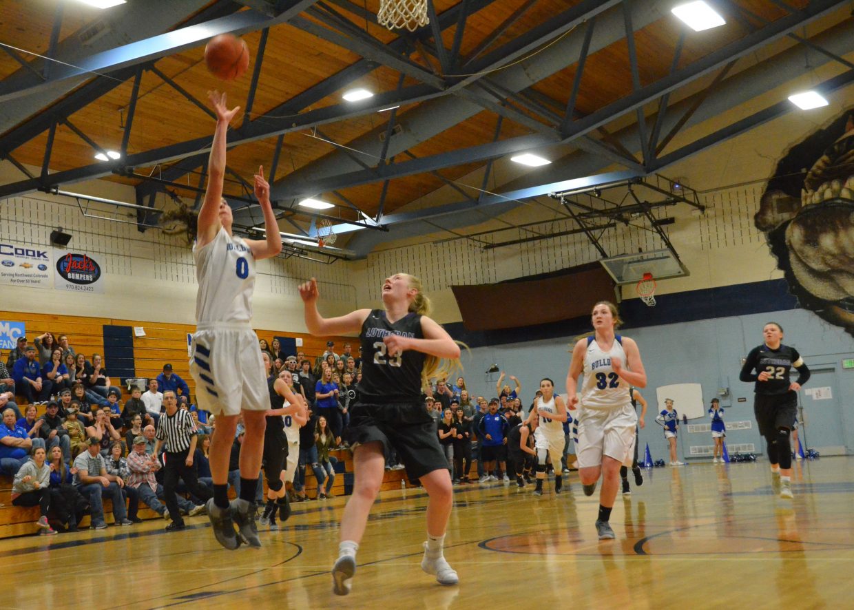 Moffat County High School's Brooke Gumber has a clean shot against Lutheran.