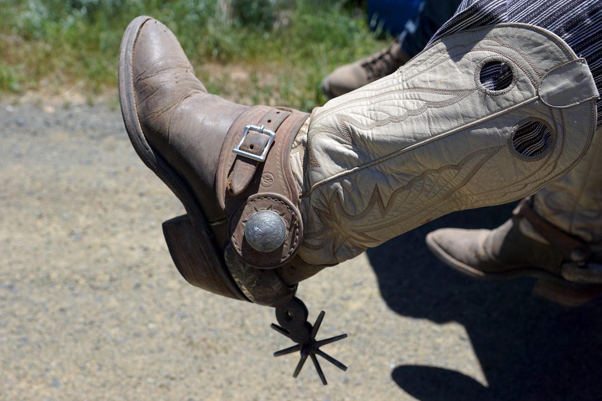 As part of the spirit of the game, cowboy action shooters adopt a western alias and costumes, often very detailed making use of antiques like the Mexican chihuahua spurs sported by this cowboy. 