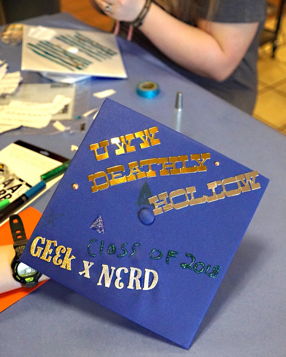 Another cap tells the story of a student headed on to college. 