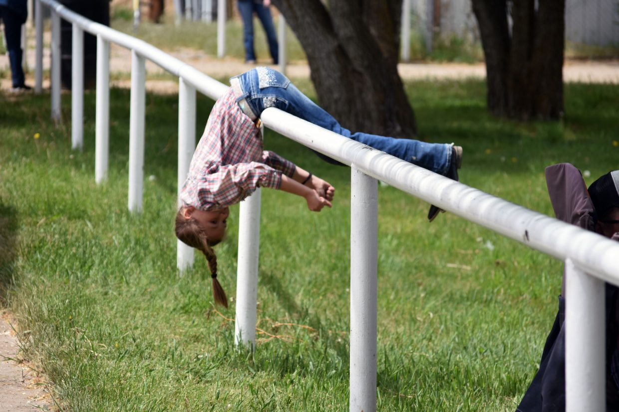 Haley Walker plays on a railing at the Moffat County Fairgrounds during the Jackpot Show, hosted by the Elkhead Wranglers 4H Club on Saturday. Walker showed a market hog. 