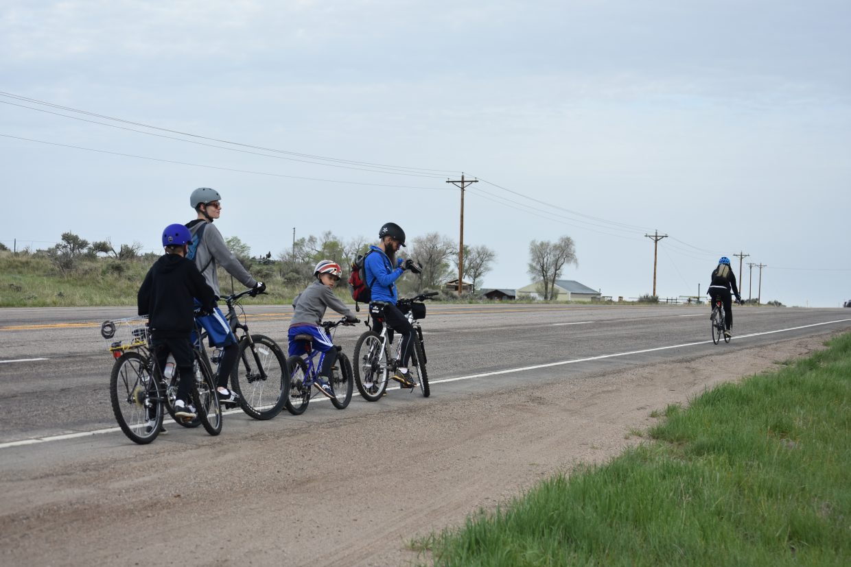 A family makes last minute adjustments on U.S. 40 before hitting the road to Maybell on Saturday's  