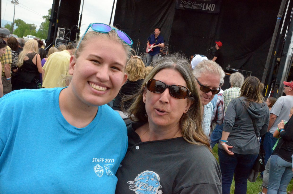 Savannah Halvorson, left, and Kari Killberg enjoy the music Saturday as Big Head Todd and the Monsters perform at the 19th annual Whittle the Wood Rendezvous.