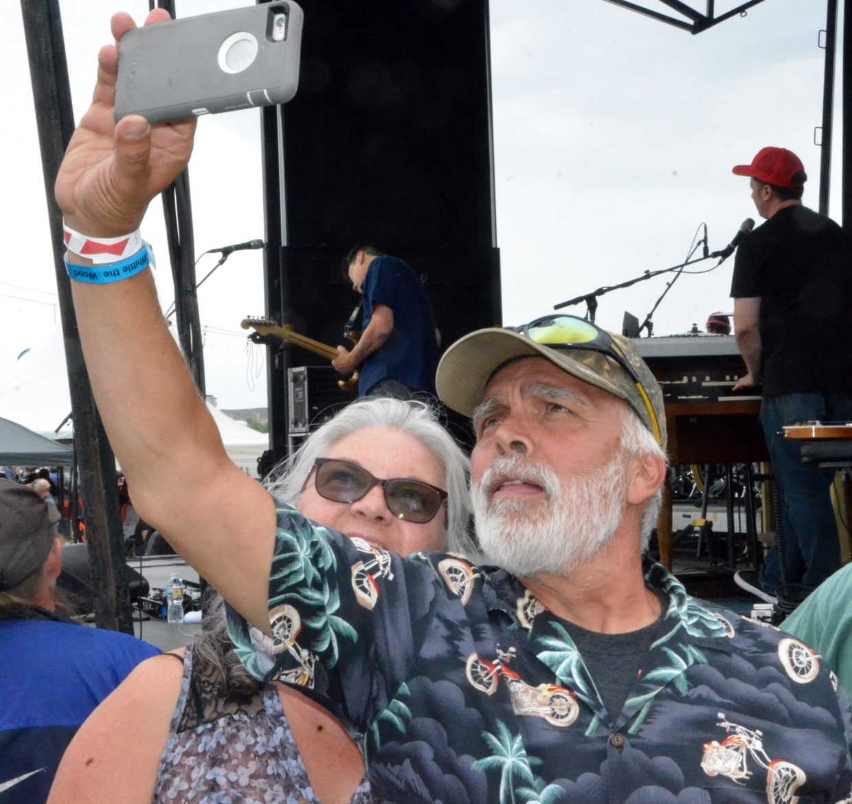 Rifle's Dino and Carmen Baldizan snap a selfie by the stage Saturday as Big Head Todd and the Monsters perform at the 19th annual Whittle the Wood Rendezvous.
