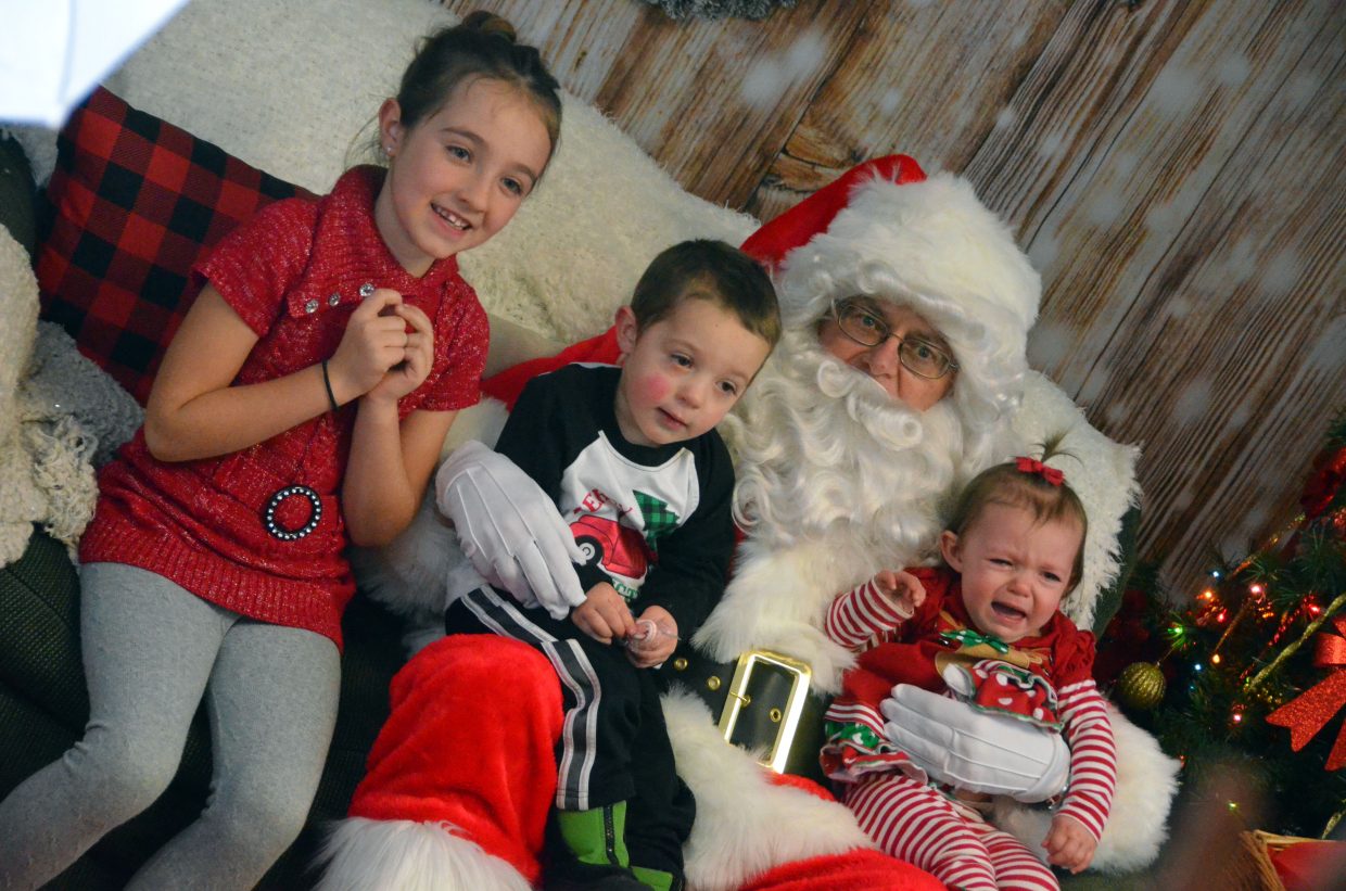 Siblings Kaylee, 7, Cameron, 2, and Holly, 1, have different reactions to meeting Santa Claus.