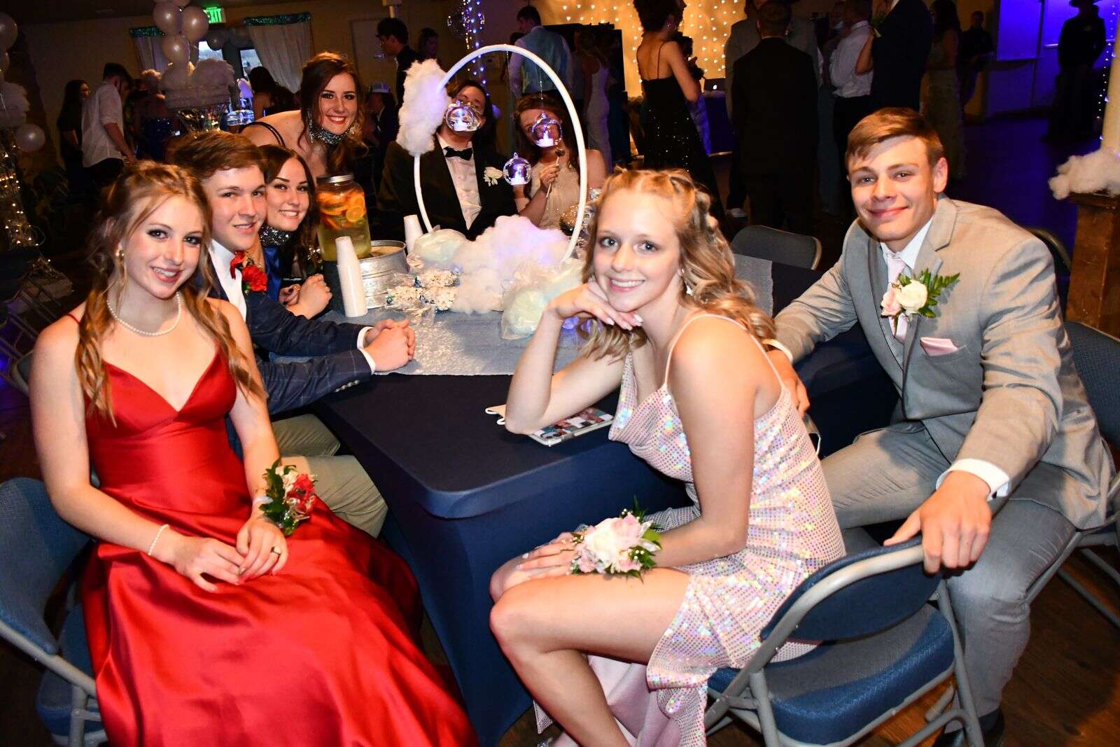 Students gather around a table at prom Saturday night. (Andy Bockelman / For Craig Press)