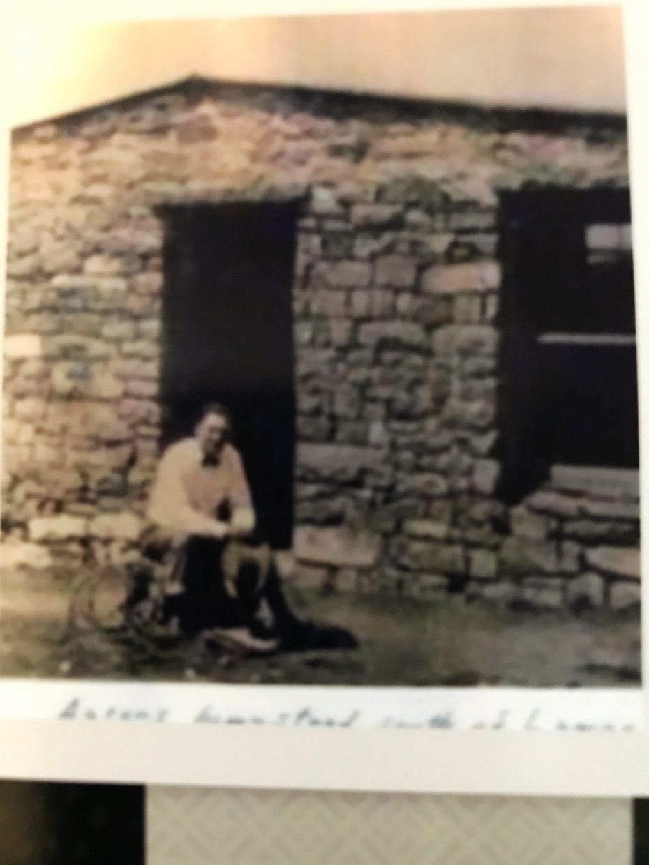 A photo of Aaron Emick in front of the original homestead.