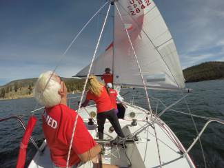 A J22 crew practices rigging the main sail and reading the wind on Lake Dillon in early July.
