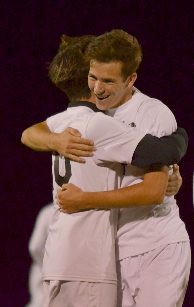Senior midfielder Cole Catron (facing) hugs junior defender Cash Koning after a home soccer victory against Steamboat Springs on Sept. 22. Catron had two goals in the 4-2 win.