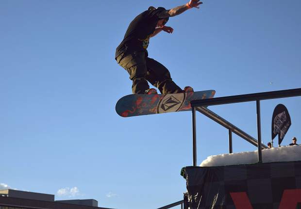 A snowboarder eyes a drop off of a ledge during the 2016 Snowboard on the Bloack rail jam in downtown Denver on Oct. 15. The on-snow event was held in temperatures near 70 degrees, followed two weeks later by record-setting temps in the 80s at Denver International Airport.