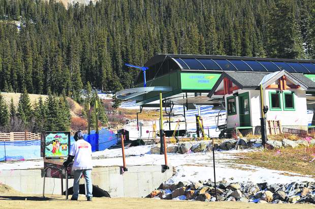 Justin Smith of Silverthorne plays a pinball machine in the dry, sunny parking lot at Arapahoe Basin a day before the ski area became the first to open in North America on Oct. 21. Since then, above-average temperatures across the state have hampered snowmaking operations at Loveland Ski Area, Keystone and Wolf Creek, leading to delayed opening dates.