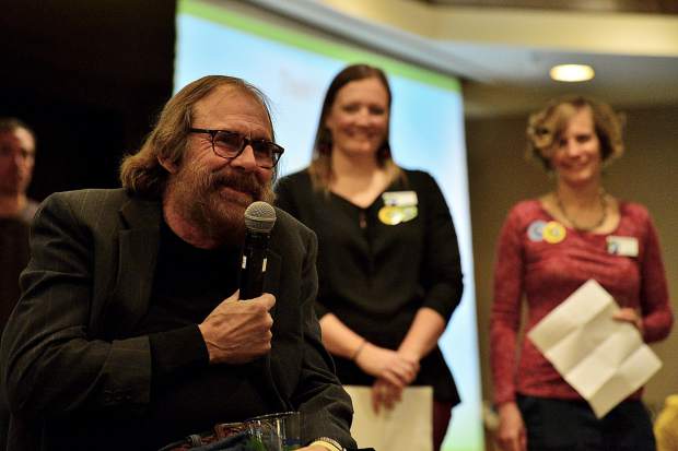 Flanked by the High County Conservation Center's Community Programs Manager Jessie Burley and Executive Director Jennifer Schenk, right, Kirby McClure toasts his later brother, Tim McClure, for whom Friday night's HC3 benefit at the DoubleTree in Breckenrdige was named.