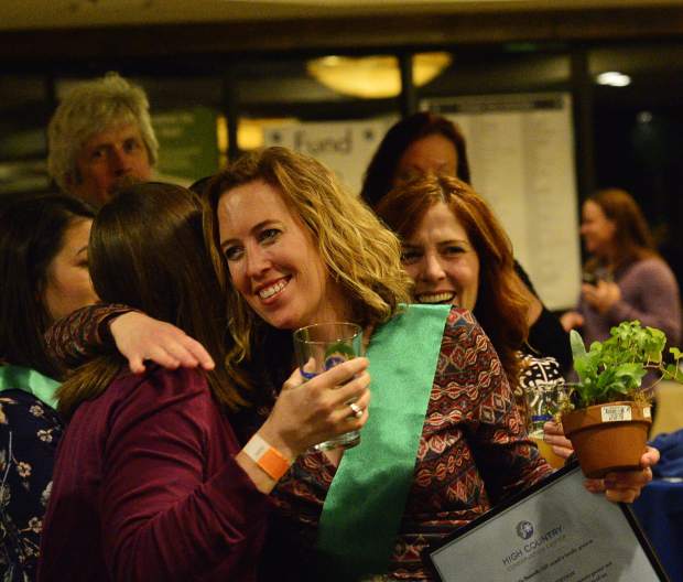 Nora Gilbertson gets a big hug after being announced as a Green Scene award winner Friday night at the 28th Tim McClure Benefit.