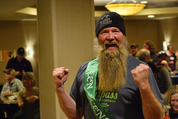 Broken Compass Brewing co-owner Jason Ford celebrates on the way up to the front of the room to accept a Green Scene award on behalf of his brewery.