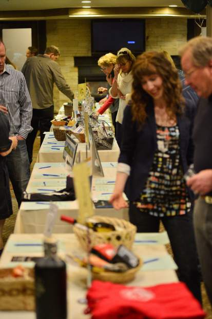 Guests peruse items set up for the silent auction Friday night at the DoubleTree in Breckenridge during the 28th Tim McClure Benefit, the High County Conservation Centerâs biggest fundraiser of the year.