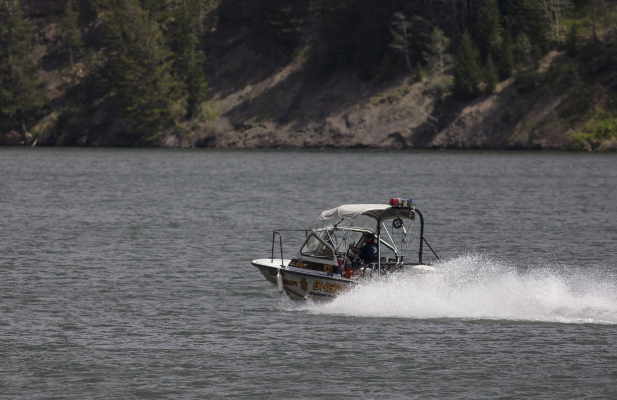 Summit County Sheriff Office deputies pilot their watercraft back to the marina at the Green Mountain Reservoir following a body recovery Wednesday, Aug. 2, near Heeney.