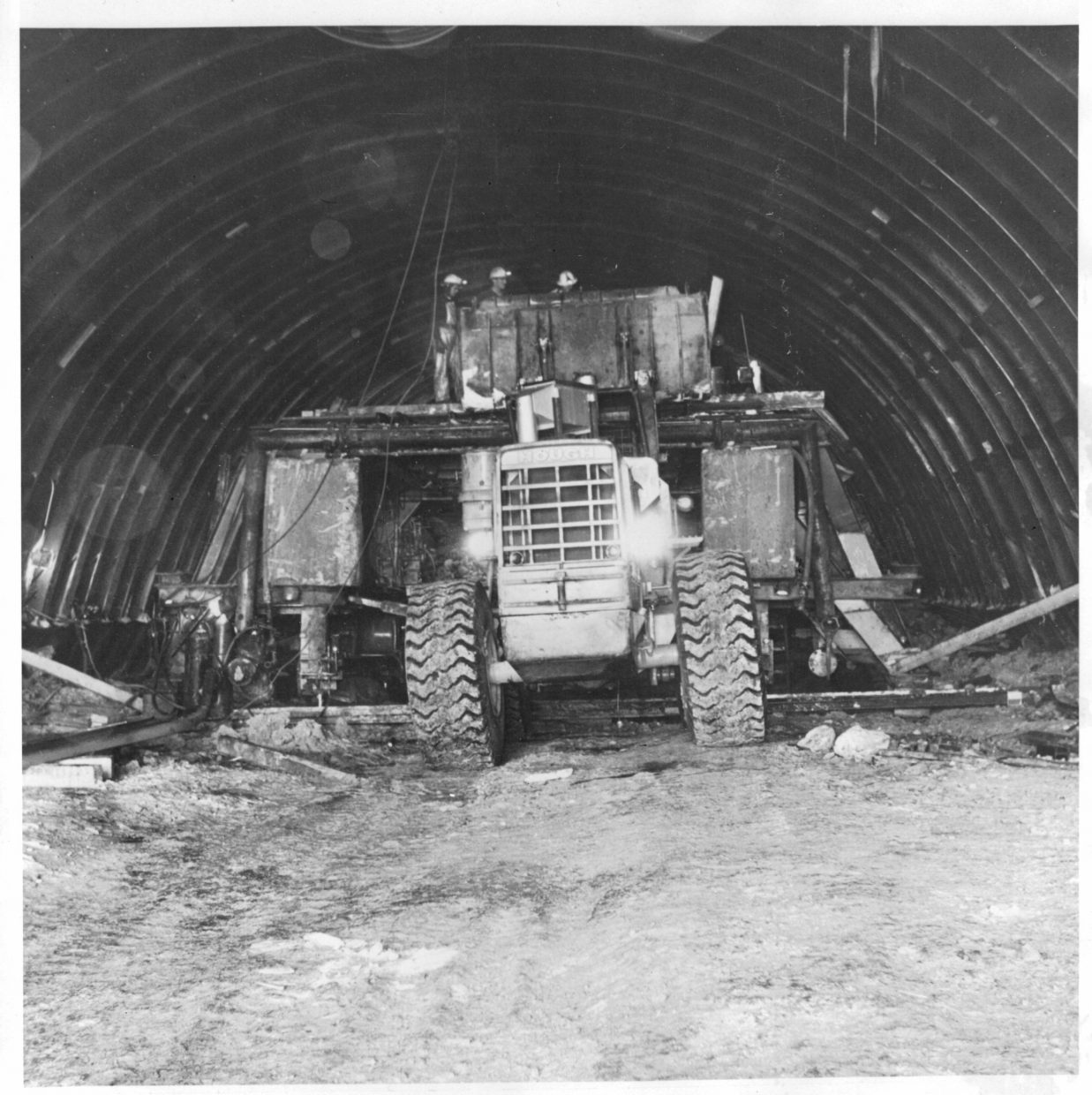 A loader servicing a jumbo drill, 1969.
