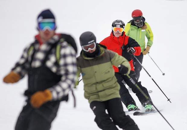 Jon Lujan, in red, a retired U.S. Marine Corps sergeant and 2014 Paralympian, skis with Keystone Adaptive Center clinic volunteers and participants as part of the Semper Fi Fund's adaptive military veterans clinic on Wednesday, Feb. 13, at Keystone Resort.