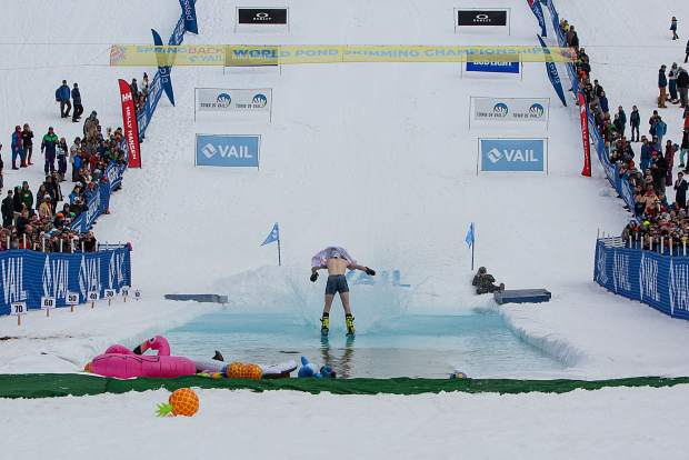 Battle Mountain High School senior Casey Cope skims the water in switch stance after hitting a jump into the water also in switch stance, a freeskiing maneuver known as a zero spin. The trick impressed judges enough to award Cope the First Place Male award at the World Pond Skimming Championships in Vail on Sunday.