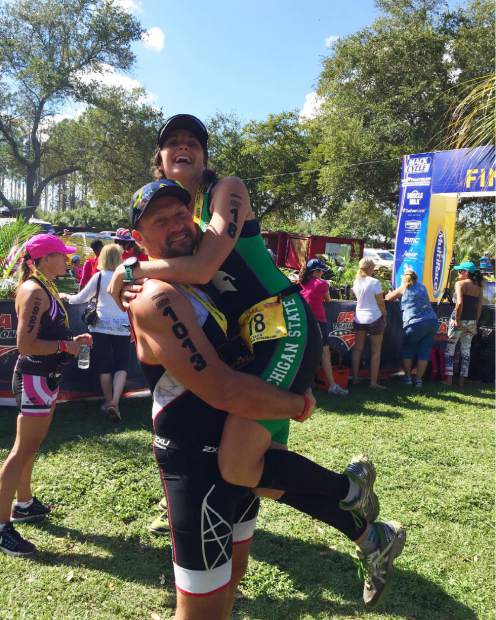 Dana Barnes jumps into the arms of her father, Michal Ovsjannikov, after completing an endurance race with him. The father-daughter duo is currently training for their first high-elevation mountaineering race, an opportunity for which Barnes is grateful following her fathering falling 60 feet down a mountain last summer in Summit County.