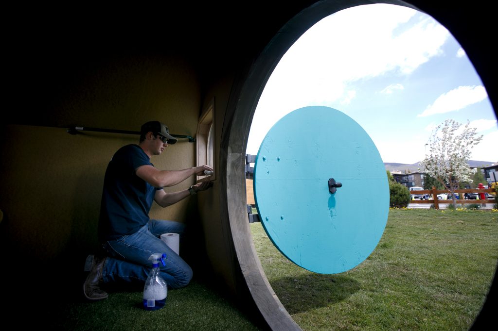 Marcus Sandberg, of Campbell Construction, makes final touches inside a playhouse Thursday, June 27, in Dillon.