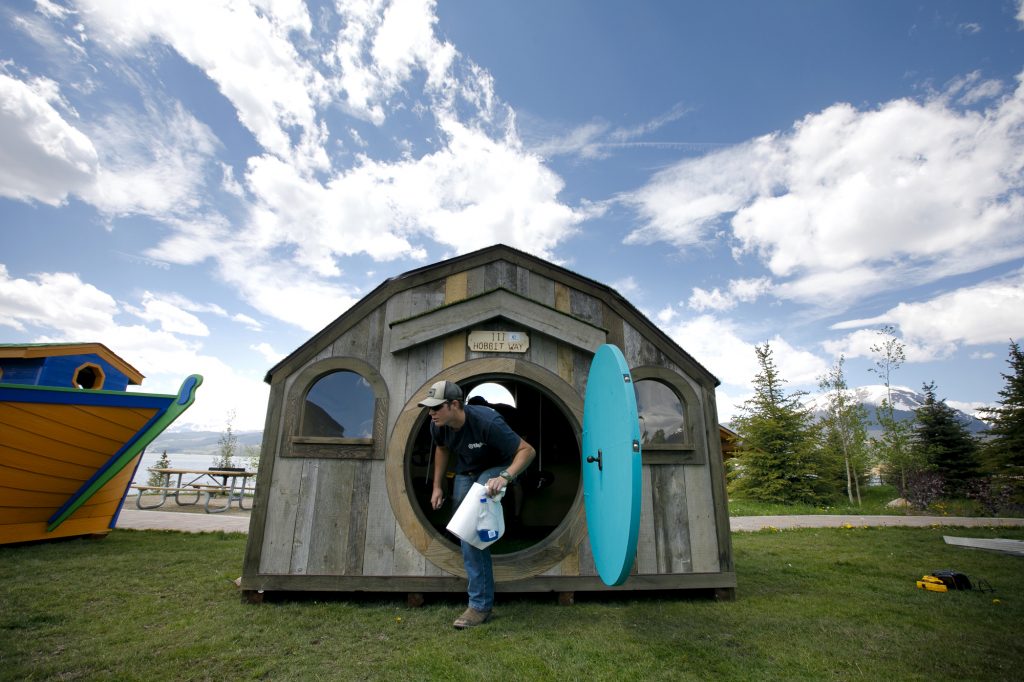 Marcus Sandberg, of Campbell Construction, makes final touches on a playhouse Thursday, June 27, in Dillon. 