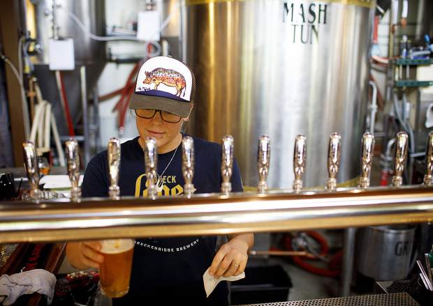Breckenridge Brewery bartender Suzanne Nance pours a beer Tuesday June 18, along Main Street in Breckenridge.