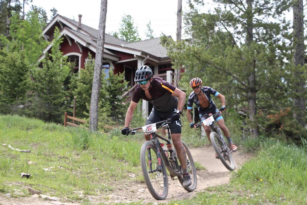 Ross Herr pedals out of a tight turn with David Gross closely behind during Thursday's Firecracker 50 mountain bike race in Breckenridge.